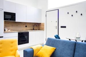 a kitchen with a blue couch and a table at Loft 11 B in Murcia