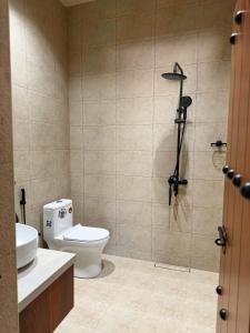 a bathroom with a toilet and a sink and a shower at بيت أرض الثراء Rich Land House in Nizwa