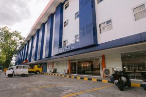 a building with a motorcycle parked in front of it at Cris Inn Tagum in Tagum