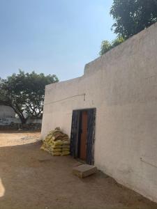 a building with a door and a pile of blankets at Hampi backyard vibes in Hospet