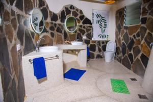 a bathroom with a giraffe themed wall at Bottle Cottage in Shimoni