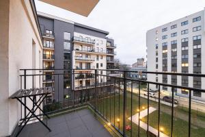 a balcony with a bench and some buildings at Luxury in City -12- Free Parking in Łódź