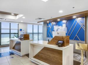 a store with blue walls and white counters in a room at Holiday Inn Express - Gulfport Beach by IHG in Gulfport +37 photos