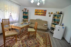 a living room with a table and chairs and a couch at Casa Marica in Ceahlău +18 photos