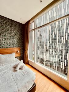 Un pat sau paturi într-o cameră la Shared Apartment - KLCC Affordable Living