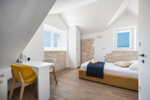 Postel nebo postele na pokoji v ubytování Villa Komelo