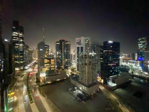 un perfil urbano por la noche con tráfico en una autopista en Business Bay - Near Metro Station - 1 Bedroom Apartments - Zada Tower - Keyrock HH en Dubái