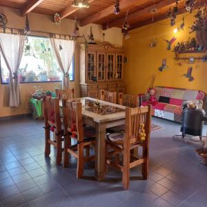 a room with a table and chairs and a couch at Casa Munay in Maimará