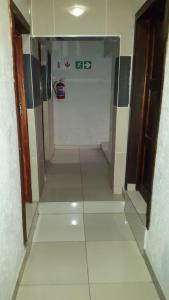 a hallway with a room with ailed floor at Monarchy Guest House in Johannesburg