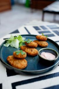 a blue plate with some food on a table at House of Stories - Indiranagar in Bengaluru