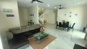 a living room with a couch and a table at Setia Residen Semi-D 2.5 storey, unlimited wifi in Sitiawan