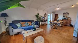 a living room with a couch and a table at L'orée du bois in Hennebont