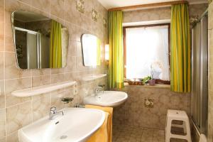 a bathroom with a sink and a mirror at Ferienwohnungen Helga Mayer inkl. Chiemgaukarte in Ruhpolding +22 photos