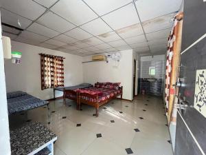 a room with a bed and a table in it at Greenlife farm resort in Sasan Gir