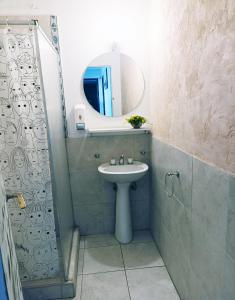 a bathroom with a sink and a mirror at Pequeña Estación B&B in Mendoza
