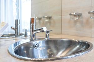 a stainless steel sink in a bathroom at Spora Chata in Nowy Targ