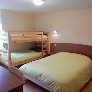a bedroom with two bunk beds and a bed at Le Gardy in Arques