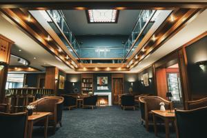 a restaurant with tables and chairs and a fireplace at Hotel Lauterbad in Freudenstadt