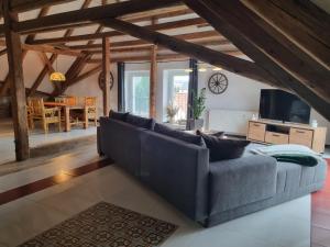 a living room with a couch and a table at Ferienwohnung Haus Madlen in Kirschau