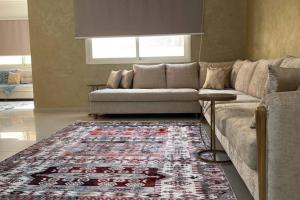 a living room with a couch and a rug at Villa near Sunset Beach in Al Khobar