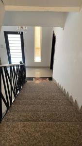 a hallway with a stairway with a door and a window at Villa near Sunset Beach in Al Khobar