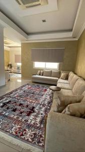 a living room with a couch and a rug at Villa near Sunset Beach in Al Khobar