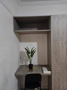 a potted plant sitting on a table in a room at Dunrobyn Court Tempo Stay in East London