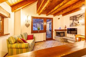 a living room with a couch and a fireplace at Casa Leonida in Bardonecchia