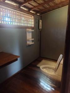 a bathroom with a toilet in a room with a window at Koh Jum Freeda Resort in Ko Jum