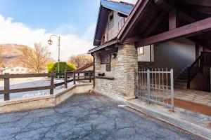 a building with a gate and a fence next to it at Casa Leonida in Bardonecchia