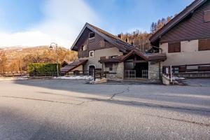 a house with a driveway in front of a building at Casa Leonida in Bardonecchia