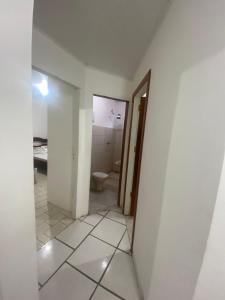 an empty bathroom with a toilet in a room at casa grande e tranquila in Porto Seguro