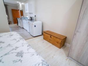 a room with a kitchen with a refrigerator and a table at AnnVilla Guesthouse in Klerksdorp