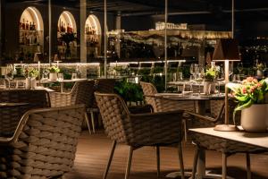 a restaurant with tables and chairs with flowers on them at 507 Athens in Athens