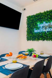 a table with plates of food on it at Guest Inn 2 Boutique House in Lisbon