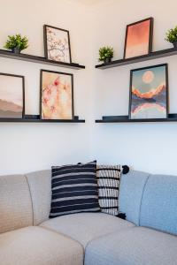 a living room with a couch and some shelves at Guest Inn 2 Boutique House in Lisbon