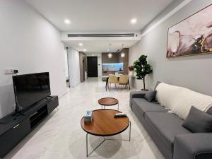 a living room with a couch and a table at EATON RESIDENCE KLCC BY JD in Kuala Lumpur