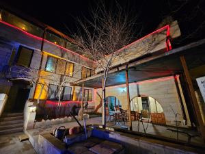 a house with a tree in front of it at night at Glorious House Goreme in Nevsehir