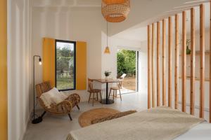 a bedroom with a bed and a table and chairs at Carmo Country Villas in Ponta Delgada