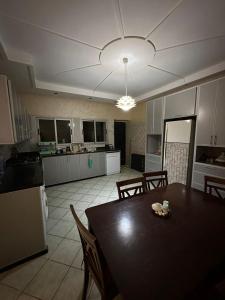 a kitchen and dining room with a table and appliances at Holikeys - El jadida - 2 Ch - Sidi Bouzid 001 in El Jadida