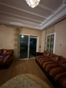 a living room with a couch and a window at Holikeys - El jadida - 2 Ch - Sidi Bouzid 001 in El Jadida