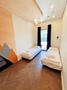 a room with two beds and a window at Vilnius legends house APARTMENT I Best for families I Free parking in Vilnius