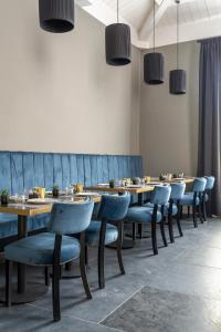 a row of tables and chairs in a restaurant at Flom Boutique Hotel in Florence