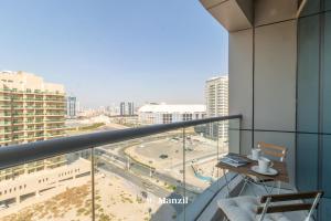 a balcony with a view of a city at Manzil - 1BR plus Maid in Dubai Sports City in Dubai