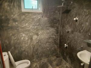 a bathroom with a shower and a toilet and a sink at Opara Palace in Weligama +31 photos