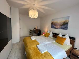 a bedroom with a large bed with a yellow blanket at Central Comfort with free parking in Salzburg