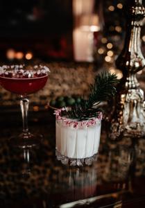 a martini and a drink on a table at The Norrmans Castle in Genarp