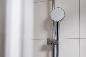 a mirror on a metal pole in a bathroom at Sleephotels Cosmos in Hamburg +78 photos