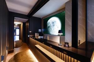 a living room with a large screen tv on a wall at Sleephotels Cosmos in Hamburg