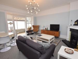 a living room with a couch and a fireplace at 2 Bed in Bexhill-on-Sea 60137 in Bexhill